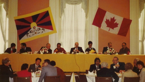 Tsering attending a conference that he organized in Canada, sitting in front of His Holiness the 14th Dalai Lama.