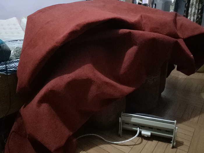 Three Gas Cylinders gathering together near an electric heater