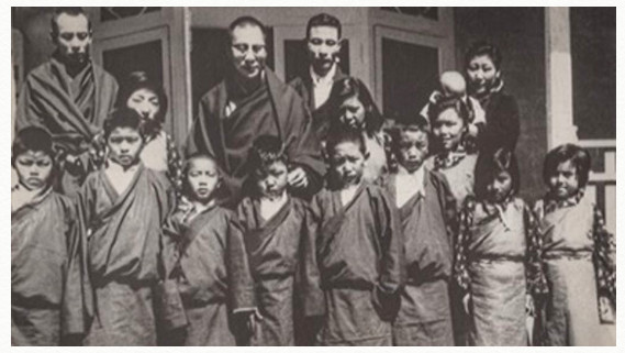 His Holiness the 14th Dalai Lama, with Tendol to his right, with the children selected to be sent to Europe in the hope of later being able to help rebuild Tibet.