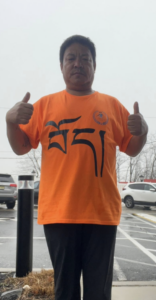 Lobga Rangzen wearing a shirt bearing Tibet in Tibetan language.